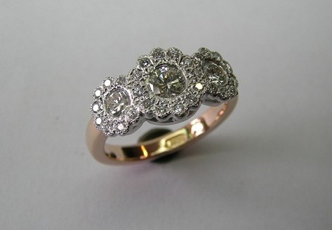 Antique style flower design three brilliant cut diamond dress ring